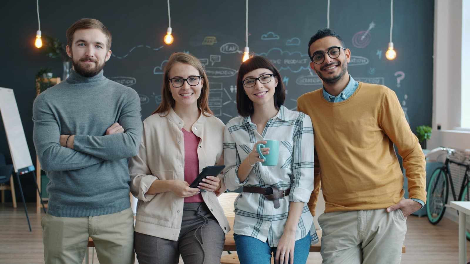 Business software team collaborating around laptops in an office